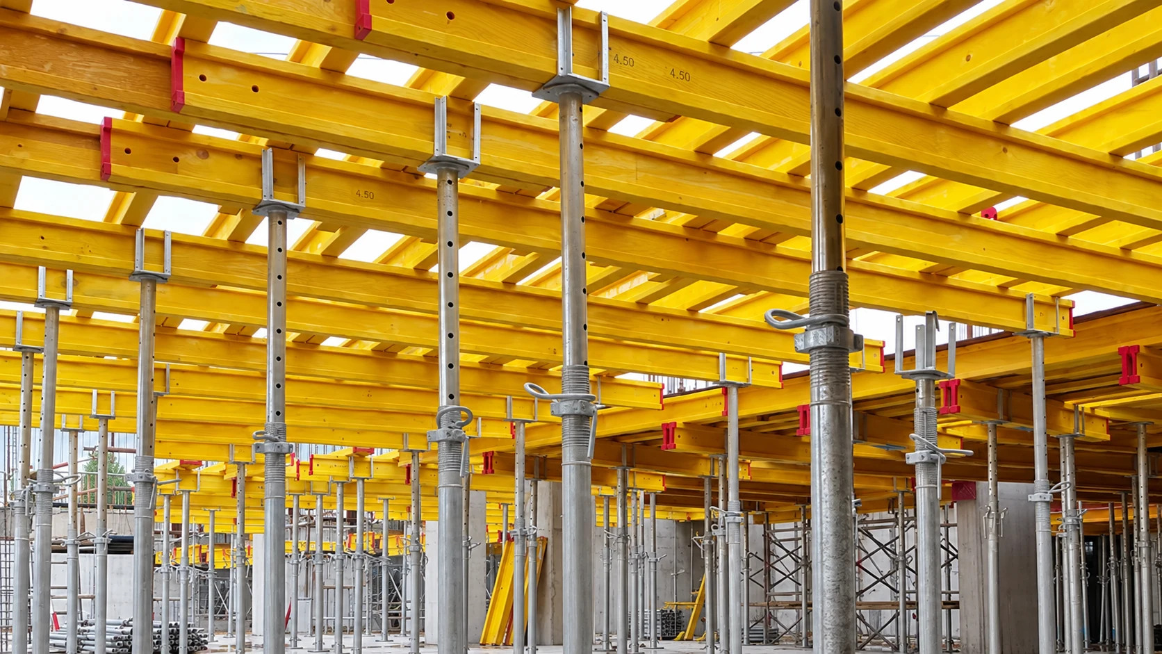 Yellow timber beam grid supported on steel prop heads