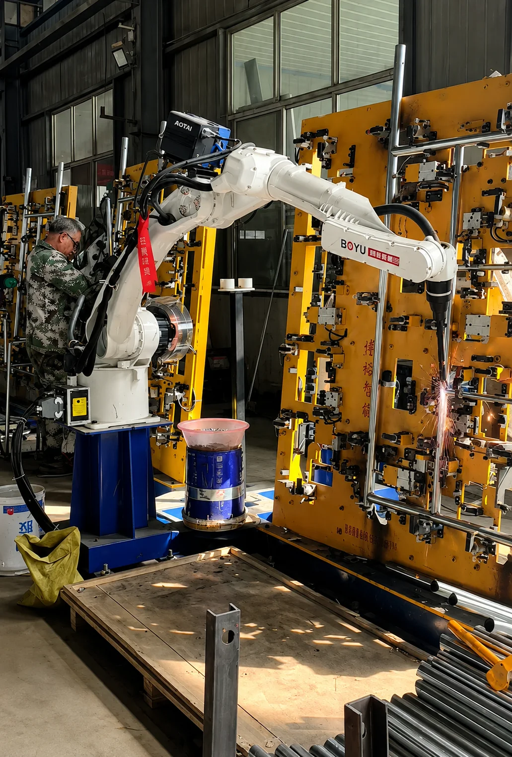 Robotic welding in progress on metal construction-support components