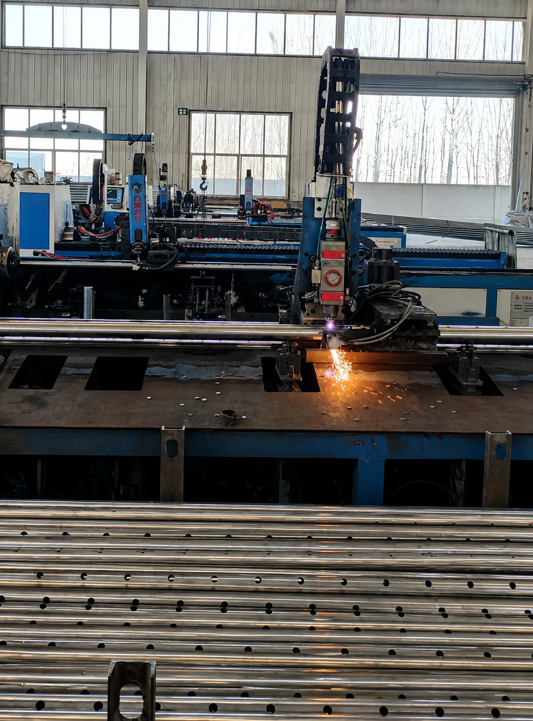 Steel tubes being cut inside the Hebei manufacturing workshop