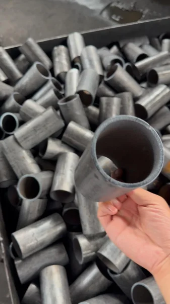 Unfinished cup-type prop adjustment component held above matching workshop stock