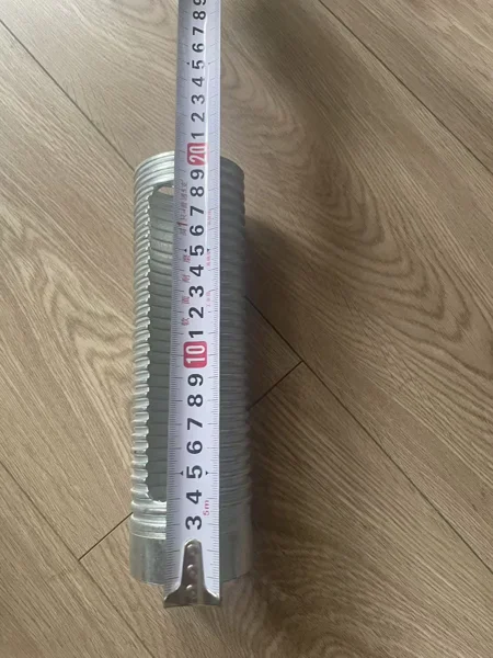 Slotted threaded sleeve beside a tape measure