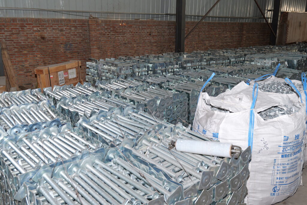 Bulk inventory of custom heavy duty screw jack bases and scaffolding adjustable jacks inside factory warehouse