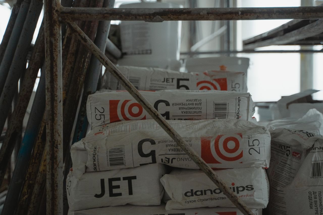 Sacks of cement placed in an indoor construction area, showcasing renovation materials.